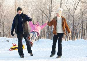 family walking in snow