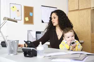 woman at computer with baby