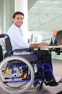 man in wheelchair using computer