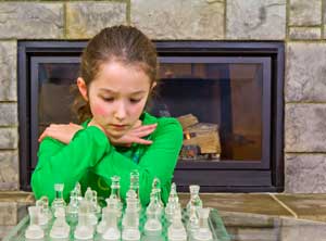 young girl playing chess